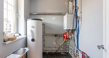 a hot water cylinder being installed in a boiler room