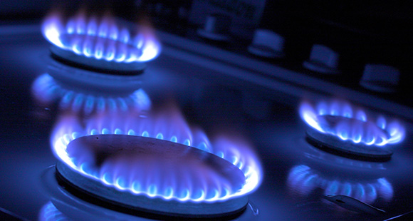 three gas hobs lit on a cooker