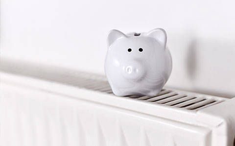 a white piggy bank on top of a radiator